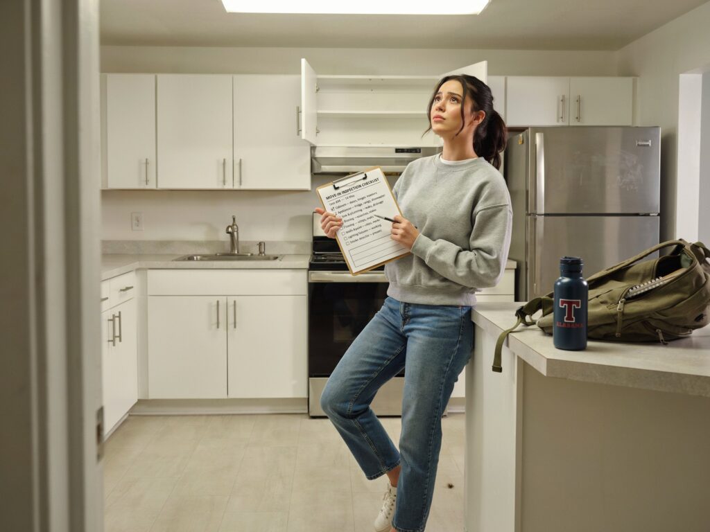 Tuscaloosa Apartment Move-In Checklist for UA Students 2 Woman holding checklist in kitchen